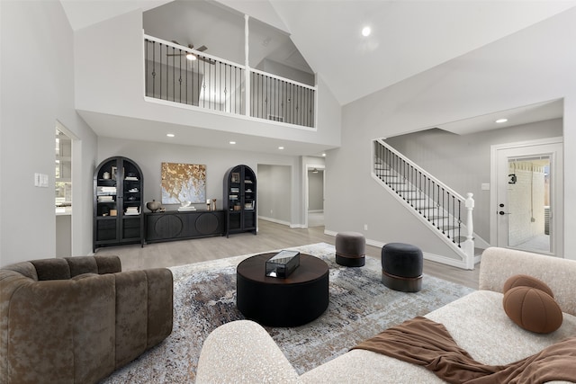 living area featuring stairway, recessed lighting, wood finished floors, and baseboards