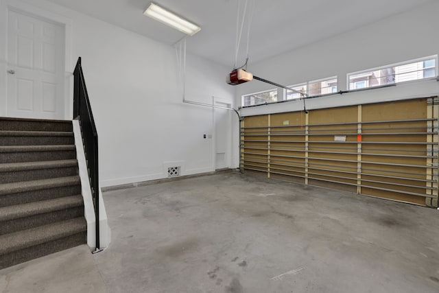 garage with a garage door opener and baseboards