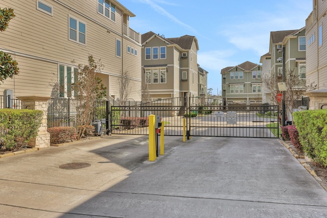 view of road featuring a residential view, a gated entry, and a gate