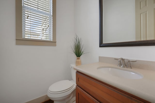 half bathroom featuring toilet and vanity