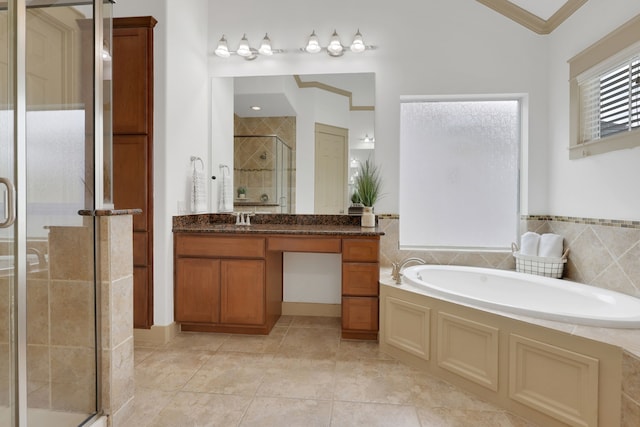 bathroom with vanity, tile patterned flooring, a shower stall, crown molding, and a garden tub