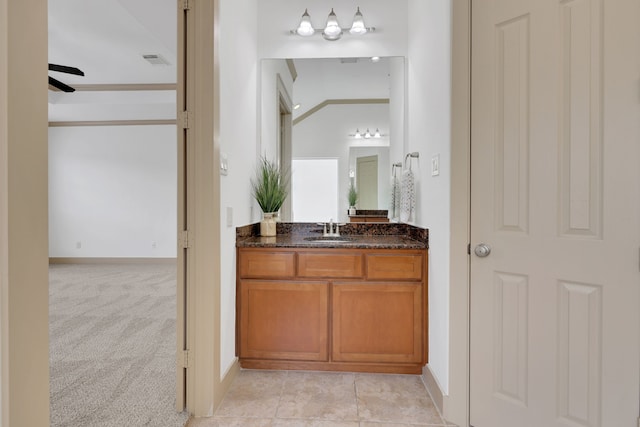 bathroom featuring vanity, baseboards, visible vents, and ceiling fan