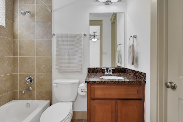 bathroom with bathing tub / shower combination, vanity, and toilet