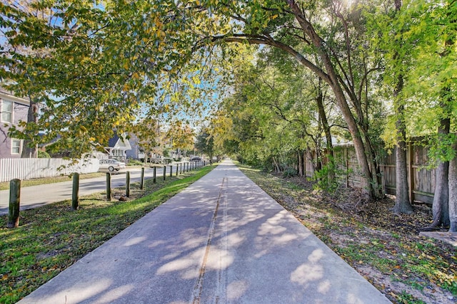 view of home's community featuring fence