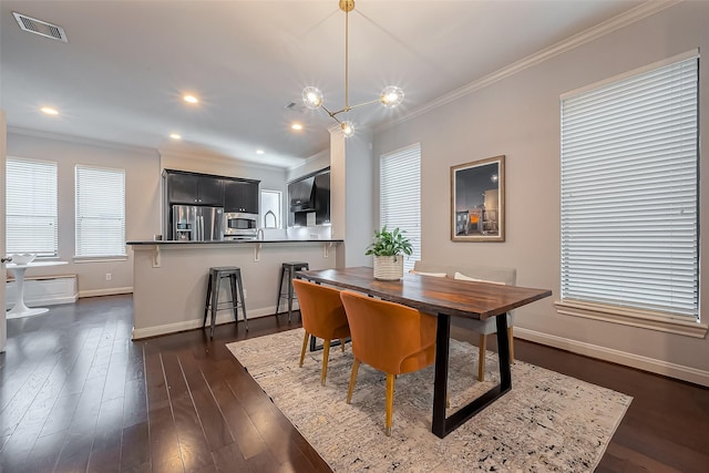 dining space featuring visible vents, baseboards, dark wood-type flooring, and crown molding