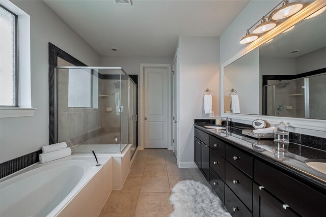 full bath with double vanity, a stall shower, a bath, and a sink