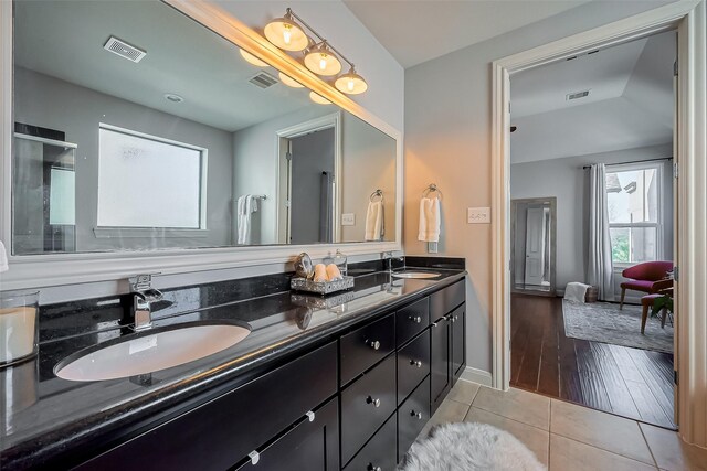 full bath featuring tile patterned flooring, visible vents, and a sink