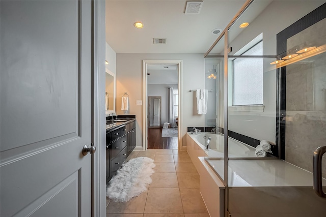 bathroom with tile patterned floors, visible vents, a stall shower, and a garden tub