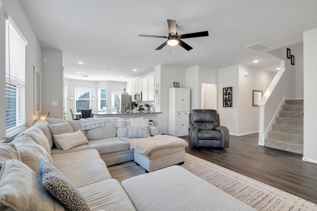 living room with visible vents, dark wood-type flooring, ceiling fan, stairway, and recessed lighting