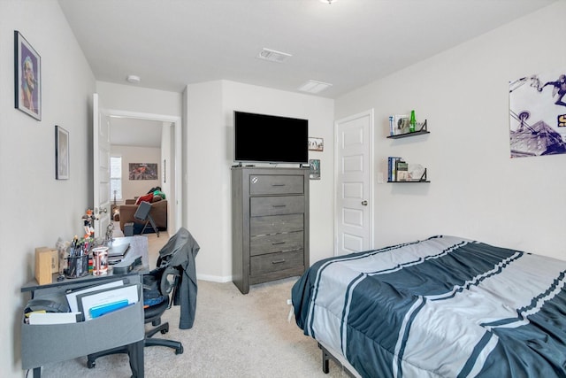 bedroom with light carpet, visible vents, and baseboards