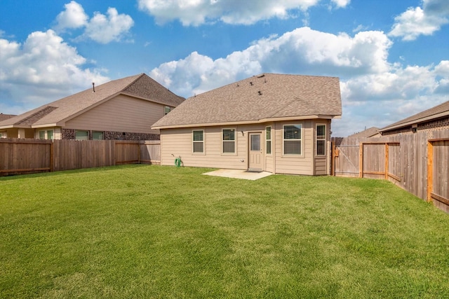 rear view of property with a fenced backyard, a patio, a yard, and roof with shingles