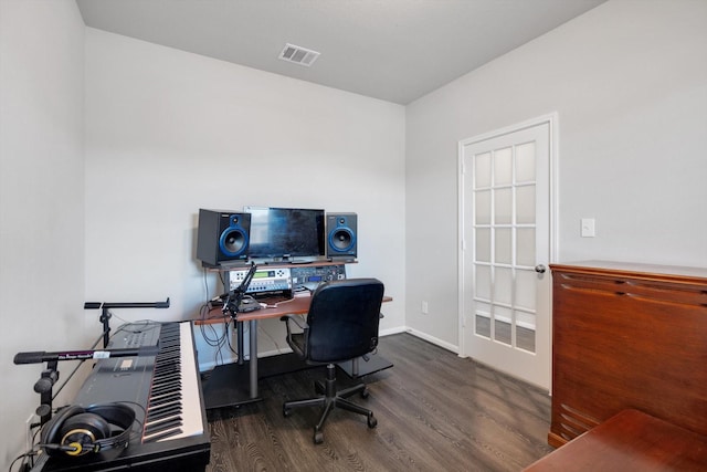 home office with visible vents, baseboards, and wood finished floors