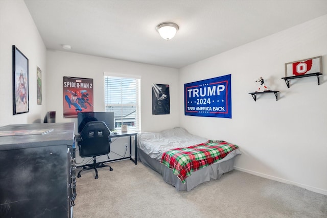 carpeted bedroom featuring baseboards