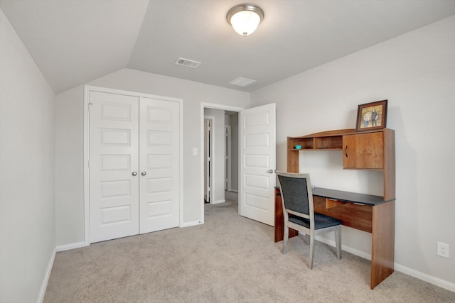 office space with visible vents, light colored carpet, baseboards, and vaulted ceiling