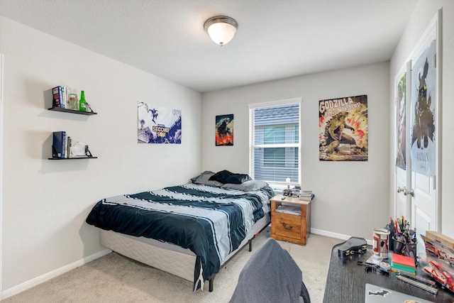 bedroom featuring baseboards and light carpet