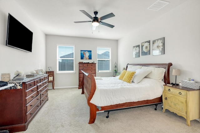 bedroom featuring visible vents, baseboards, light colored carpet, and ceiling fan