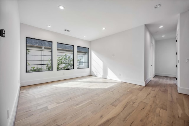 spare room featuring recessed lighting, visible vents, light wood finished floors, and baseboards