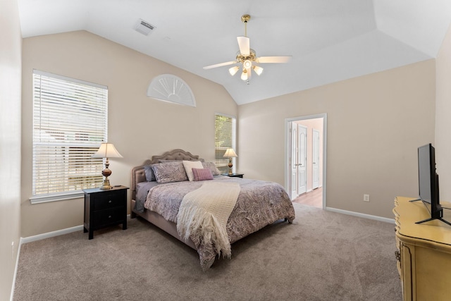 bedroom featuring visible vents, light colored carpet, and vaulted ceiling