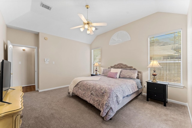 bedroom with vaulted ceiling, baseboards, visible vents, and light carpet