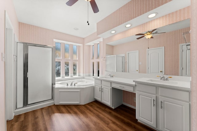 bathroom with a shower stall, wallpapered walls, ceiling fan, and a sink