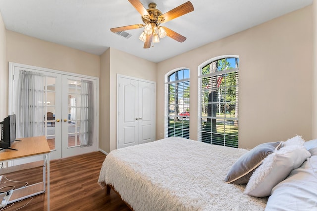 bedroom featuring visible vents, french doors, a closet, a ceiling fan, and dark wood-style flooring