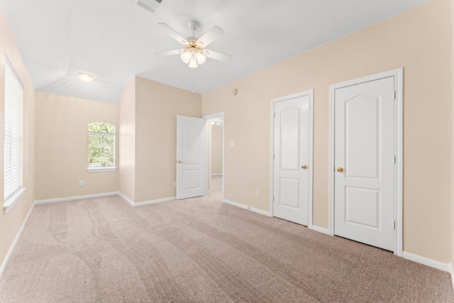 unfurnished bedroom with visible vents, baseboards, and carpet