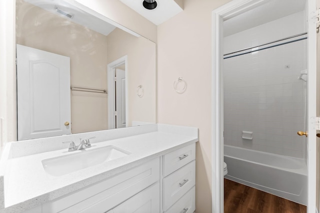 full bathroom featuring visible vents, toilet, shower / bathtub combination, wood finished floors, and vanity