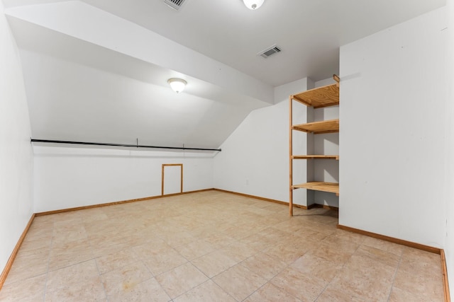 bonus room featuring lofted ceiling, baseboards, and visible vents