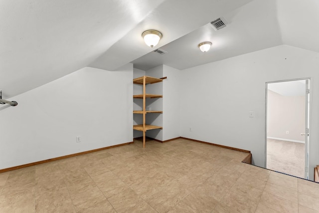 bonus room featuring visible vents, baseboards, and lofted ceiling