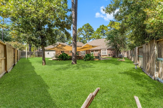 view of yard with a fenced backyard