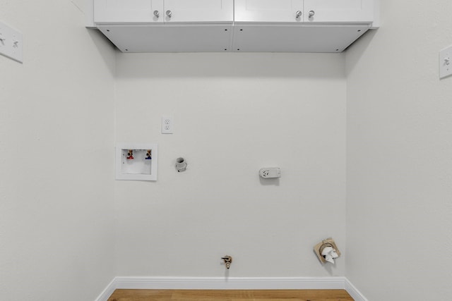 washroom with baseboards, hookup for a gas dryer, cabinet space, and washer hookup