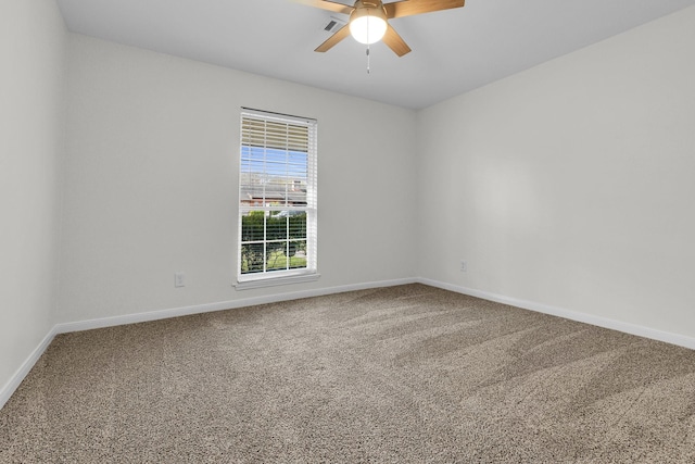 unfurnished room with baseboards, carpet, and a ceiling fan