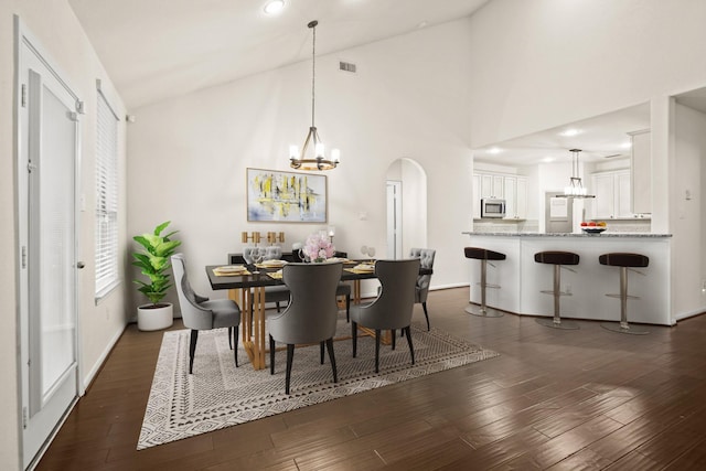 dining room with dark wood finished floors, an inviting chandelier, and visible vents