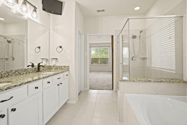 full bathroom featuring visible vents, a stall shower, a sink, tile patterned flooring, and a garden tub