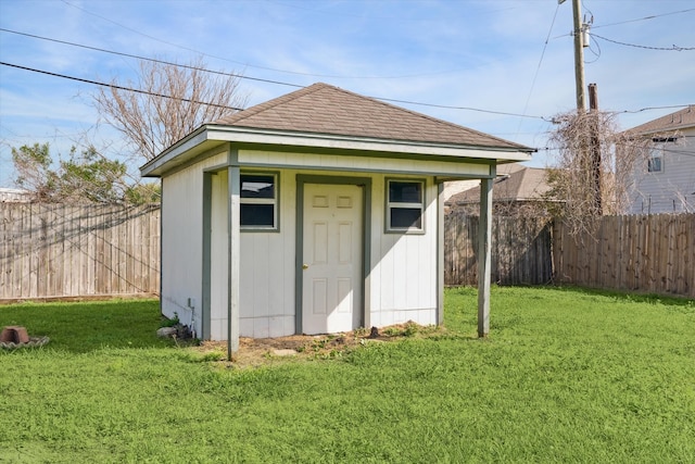 view of outdoor structure with an outbuilding and a fenced backyard