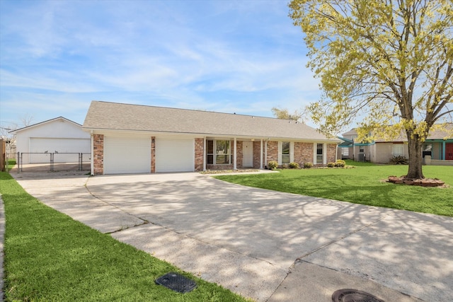 ranch-style house with a front lawn, an attached garage, brick siding, and driveway