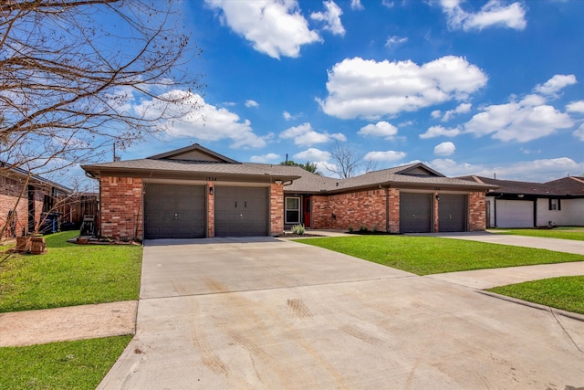 view of front of property with brick siding, a garage, a front yard, and driveway