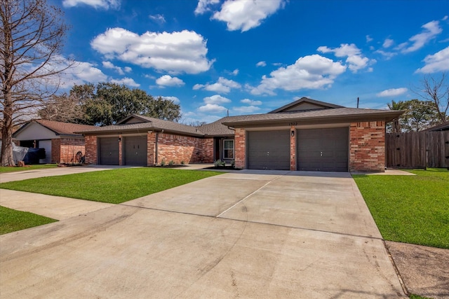 view of front facade featuring a front lawn, brick siding, a garage, and driveway