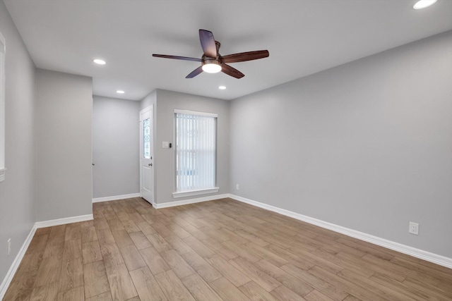 unfurnished room with a ceiling fan, recessed lighting, wood finished floors, and baseboards