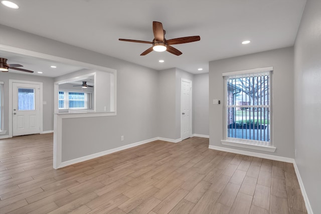 empty room with recessed lighting, light wood-style floors, baseboards, and ceiling fan