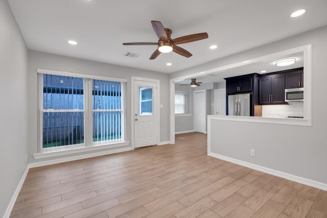 unfurnished living room with visible vents, light wood-style flooring, a ceiling fan, recessed lighting, and baseboards