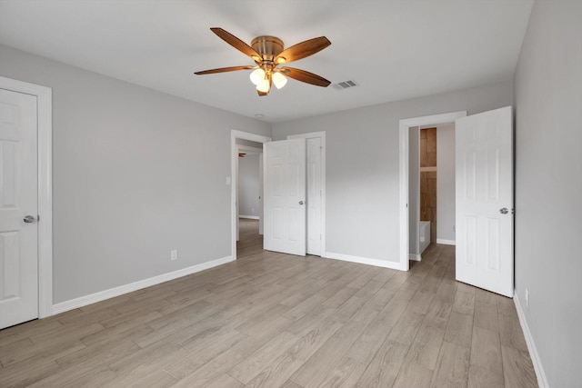 unfurnished bedroom with visible vents, ceiling fan, light wood-type flooring, and baseboards