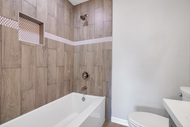 bathroom featuring baseboards, vanity, toilet, and washtub / shower combination