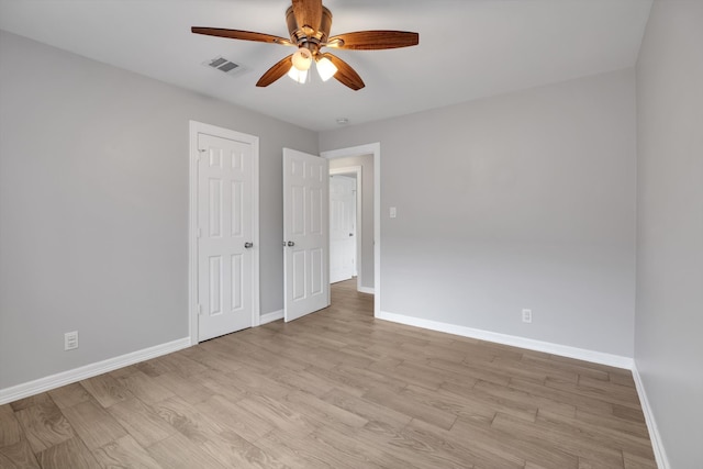 unfurnished bedroom featuring visible vents, baseboards, and light wood-style floors