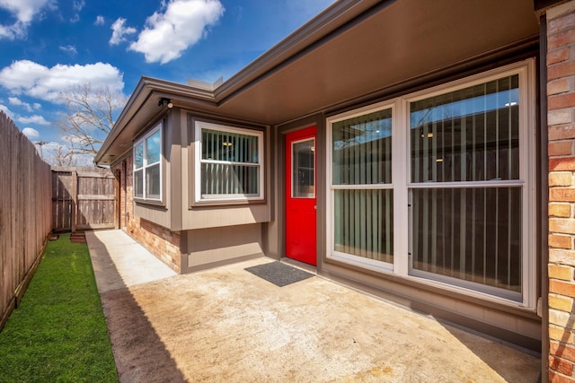 doorway to property with a patio area and fence