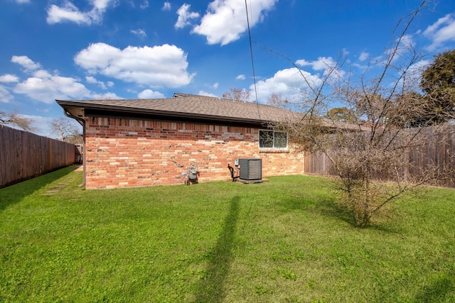 view of property exterior with cooling unit, a lawn, a fenced backyard, and brick siding