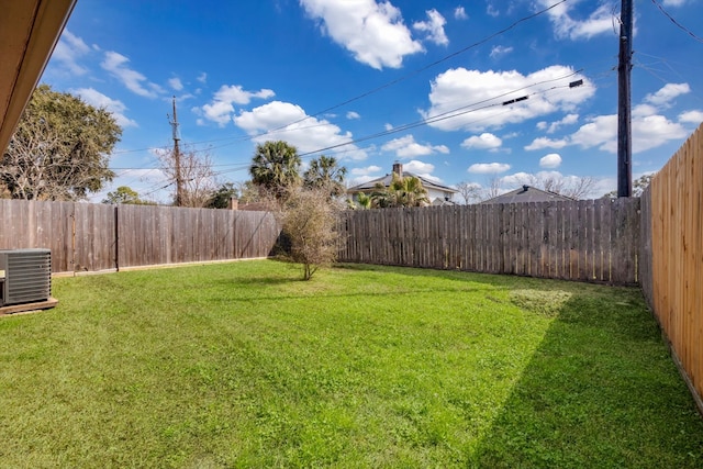 view of yard featuring central air condition unit and a fenced backyard