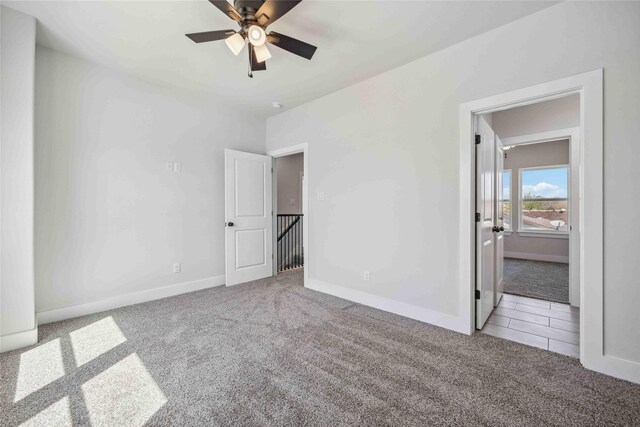 4715 Ward St, Houston, TX 77021 - unfurnished bedroom with carpet flooring, baseboards, and a ceiling fan