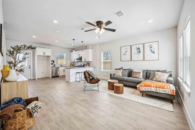4715 Ward St, Houston, TX 77021 - living area featuring baseboards, recessed lighting, light wood finished floors, and a ceiling fan