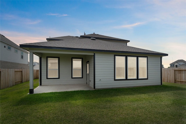 352 Spruce Oak Ln, Waller, TX 77484 - back of house at dusk featuring a patio and a shingled roof
